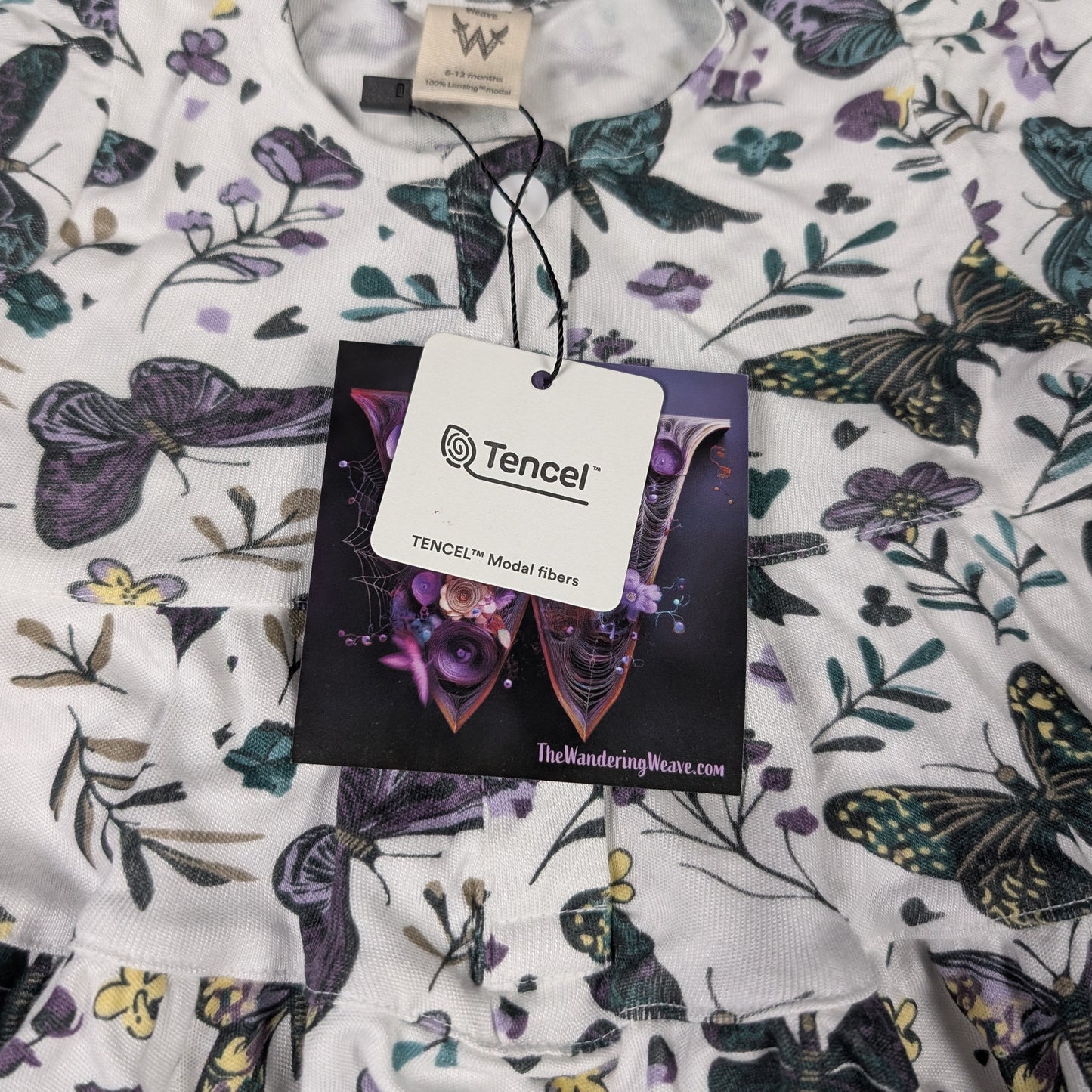 Fabric with butterfly pattern and Tencel label on a plain background