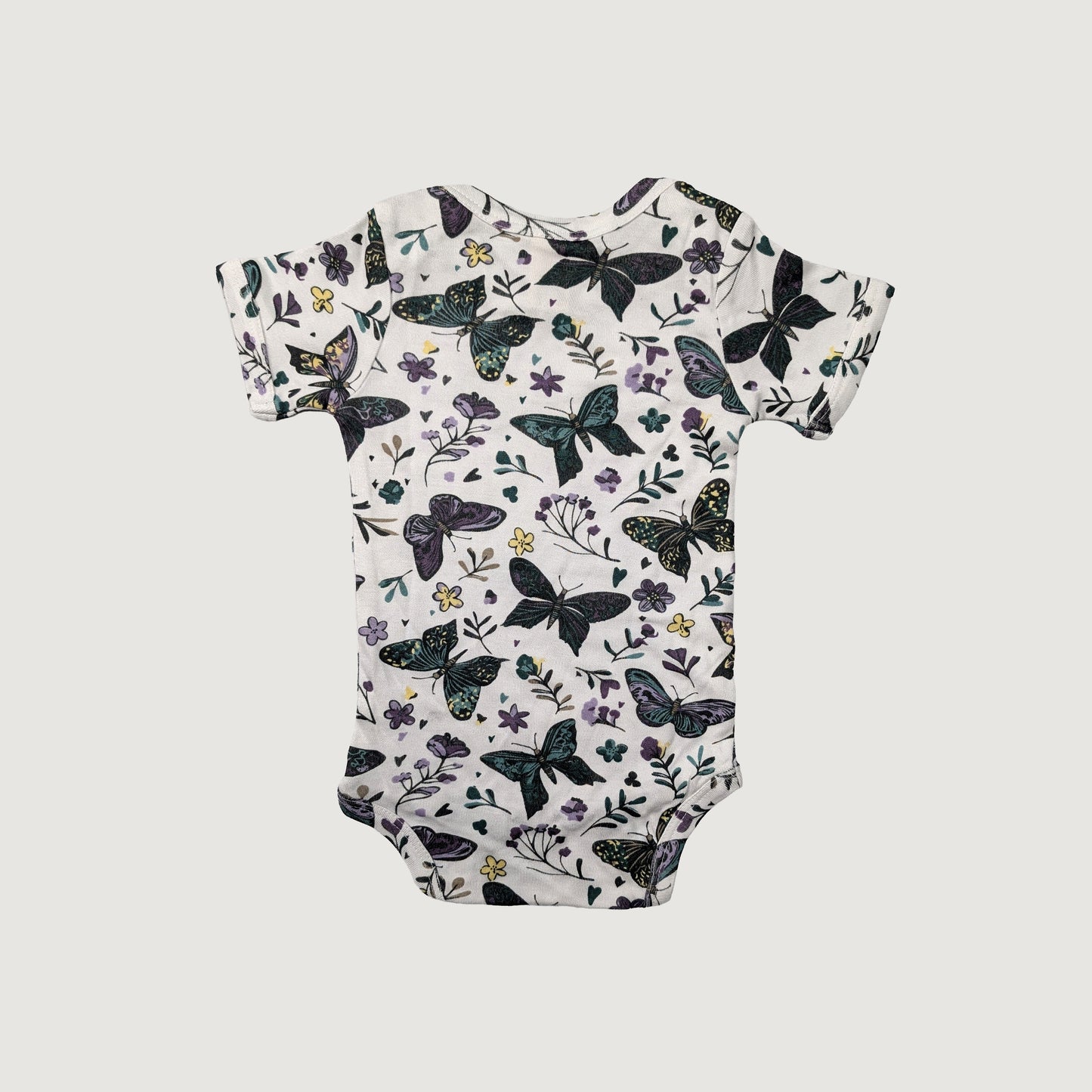 Lap neck baby onesie with butterfly and floral pattern on a white background