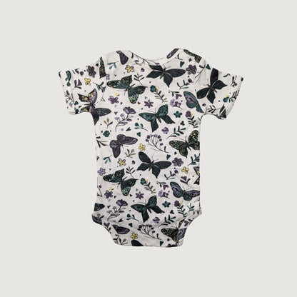 Lap neck baby onesie with butterfly and floral pattern on a white background
